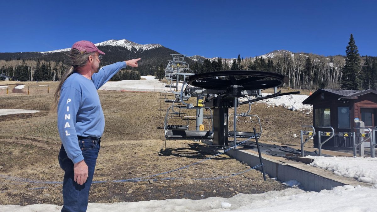 Flagstaff meteorologist Mark Stubblefield points at the location where the 10,000 gallon tank of reclaimed wastewater is held on the slopes of the Arizona Snowbowl, a resort that has sparked the indignation of 13 Native American tribes.