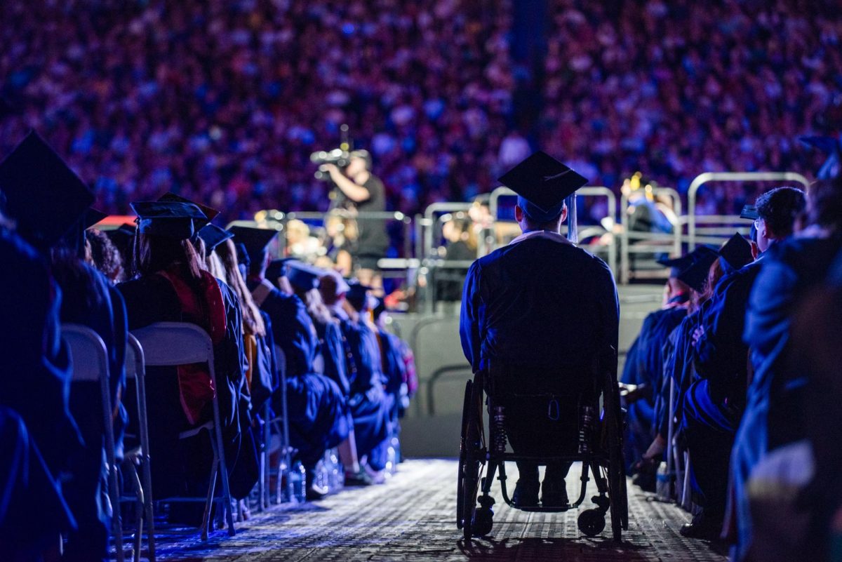 University of Arizona graduates look upon the stage at Arizona Stadium on May 16. Students filled the rows in silence as speakers continued the evening’s program.